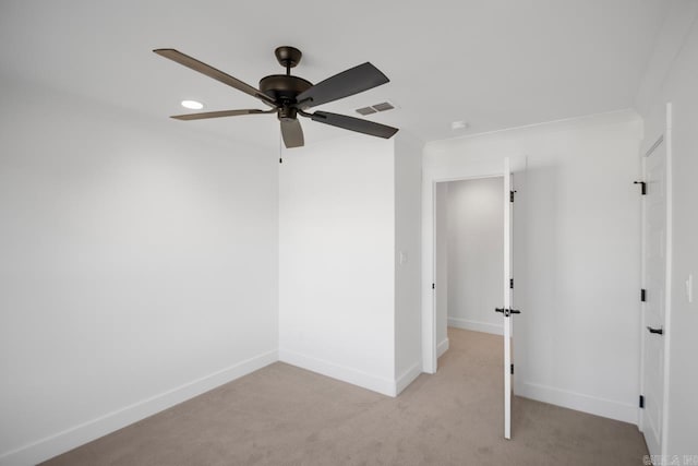 spare room with light carpet, ceiling fan, and ornamental molding