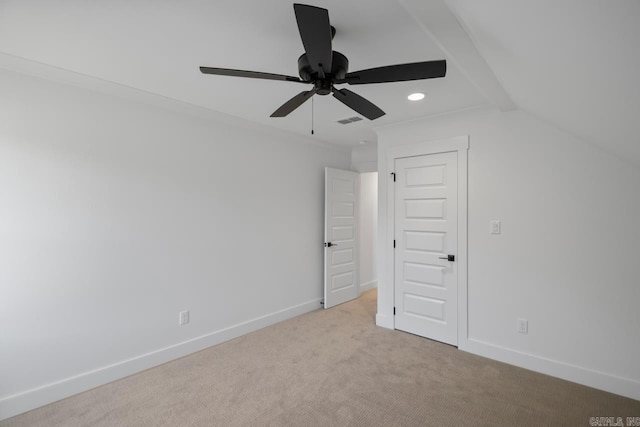 unfurnished bedroom featuring lofted ceiling, light colored carpet, and ceiling fan