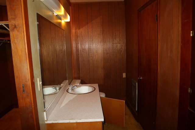 bathroom with wooden walls and vanity