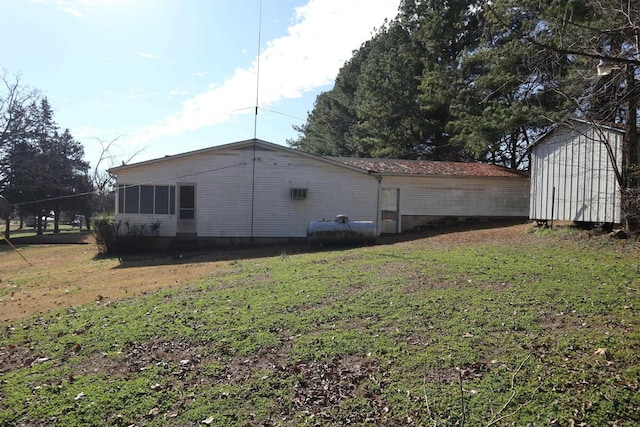 view of property exterior with a yard and a shed