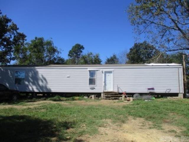 back of house with a lawn