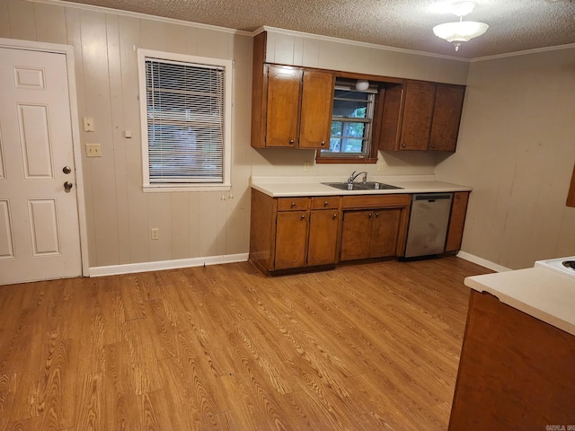 kitchen with sink, light hardwood / wood-style floors, a textured ceiling, and dishwasher