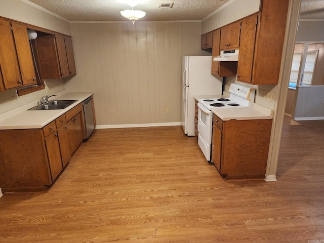 kitchen with white appliances, light wood-type flooring, a textured ceiling, and sink