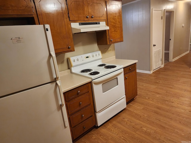 kitchen featuring white appliances and light hardwood / wood-style flooring