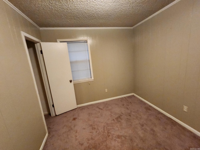 unfurnished room with a textured ceiling, carpet floors, and crown molding