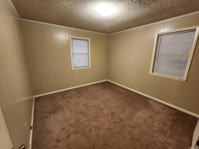 carpeted spare room featuring a textured ceiling and ornamental molding