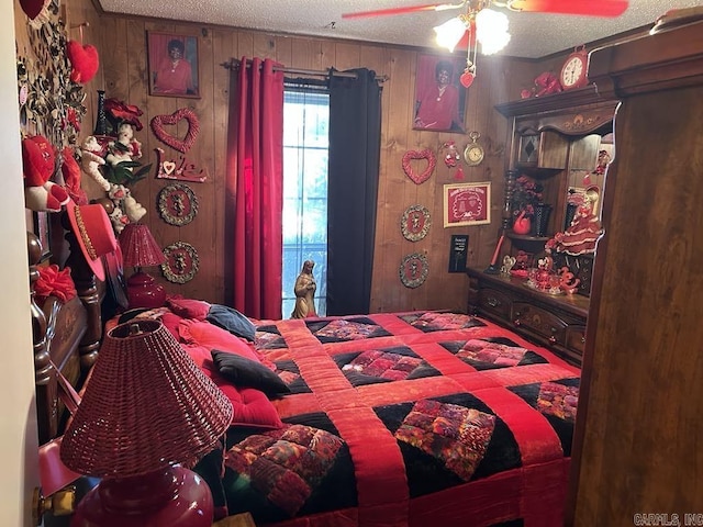 bedroom with wooden walls, a textured ceiling, and ceiling fan