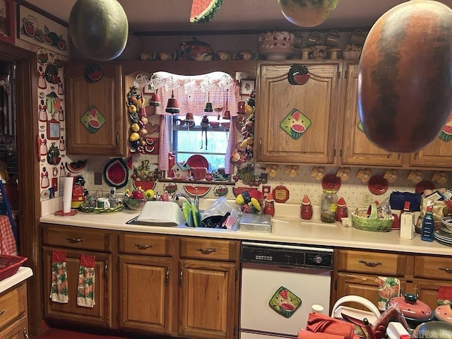 kitchen featuring white dishwasher and sink