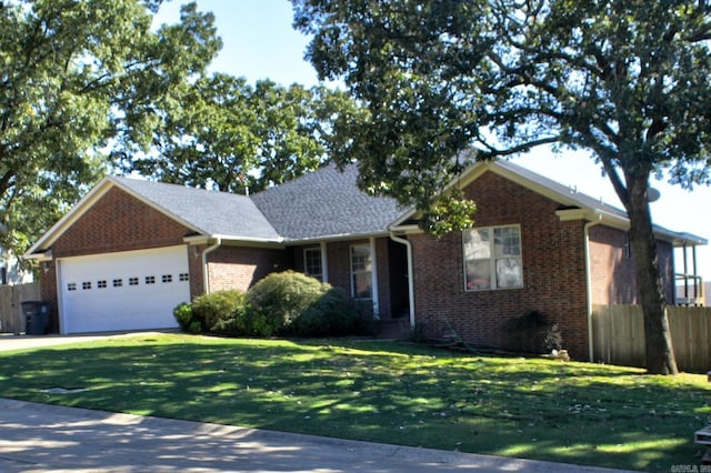 view of front of property featuring a front yard and a garage