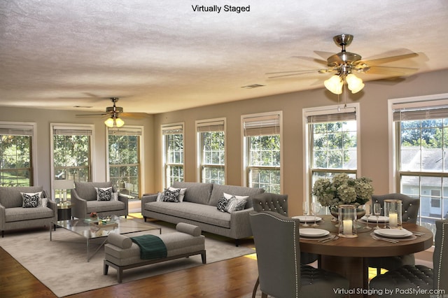 living room featuring ceiling fan and hardwood / wood-style flooring