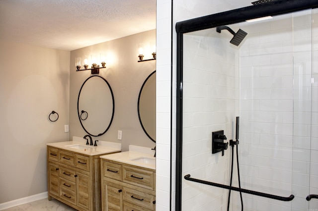 bathroom with a textured ceiling, walk in shower, and vanity