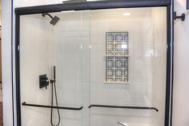 bathroom with a shower with shower door