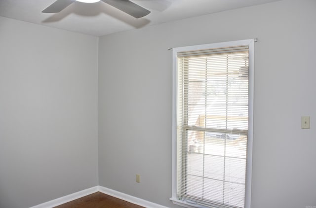 spare room with ceiling fan and dark hardwood / wood-style flooring