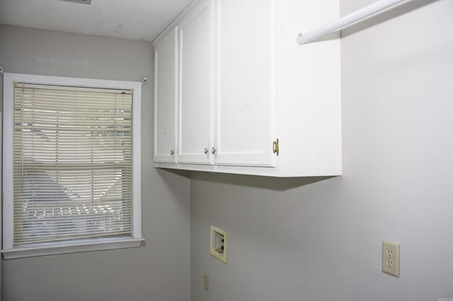 washroom with washer hookup and cabinets