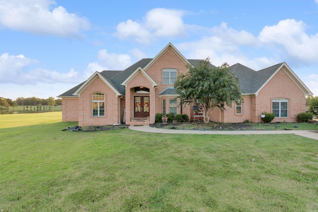 front facade featuring french doors and a front lawn