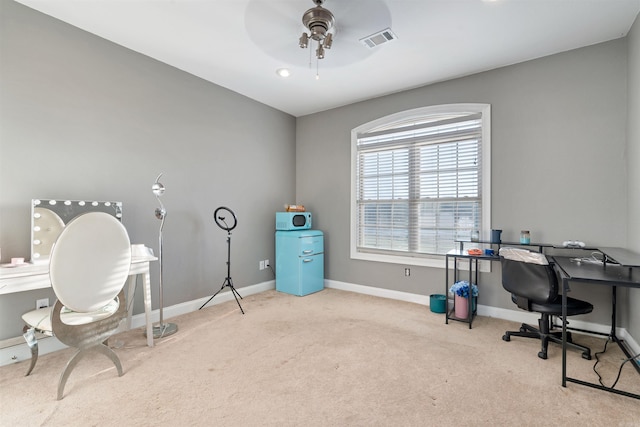 office area with ceiling fan and light carpet