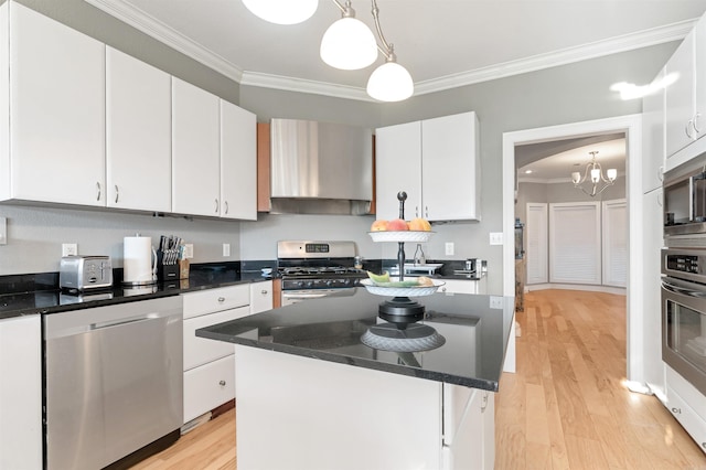 kitchen featuring appliances with stainless steel finishes, white cabinets, and wall chimney exhaust hood