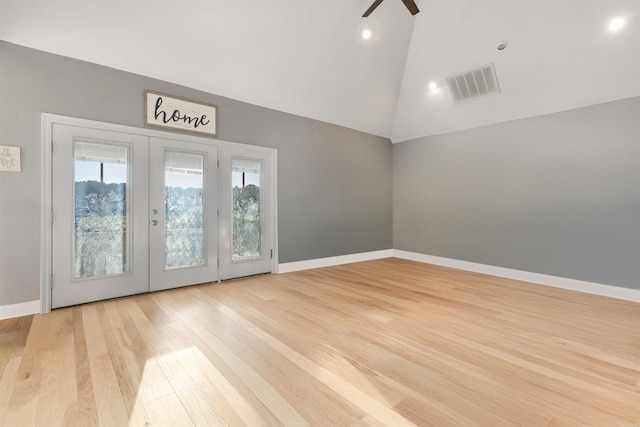 interior space with ceiling fan, french doors, light wood-type flooring, and high vaulted ceiling