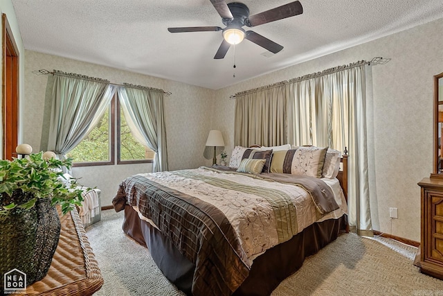 carpeted bedroom featuring ceiling fan and a textured ceiling