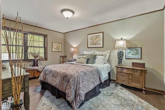 bedroom with ornamental molding and dark hardwood / wood-style floors