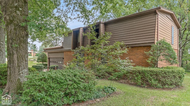 view of home's exterior with a lawn and a garage