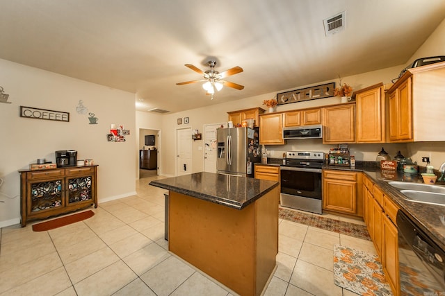 kitchen with stainless steel appliances, sink, a center island, ceiling fan, and light tile patterned floors