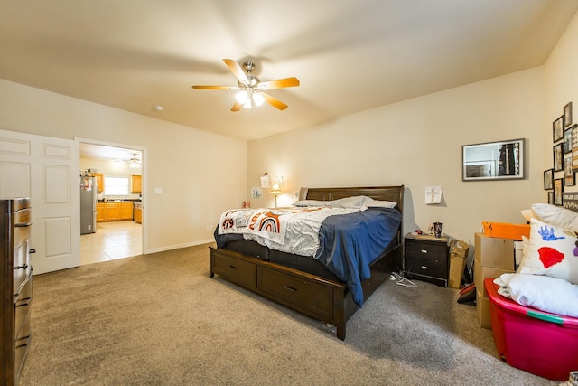 carpeted bedroom with stainless steel refrigerator and ceiling fan