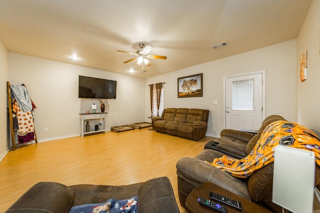 living room featuring hardwood / wood-style flooring and ceiling fan