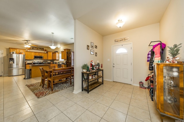 entrance foyer featuring ceiling fan and light tile patterned floors