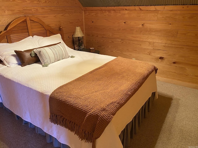 carpeted bedroom with wood walls