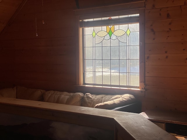 bedroom featuring wood walls