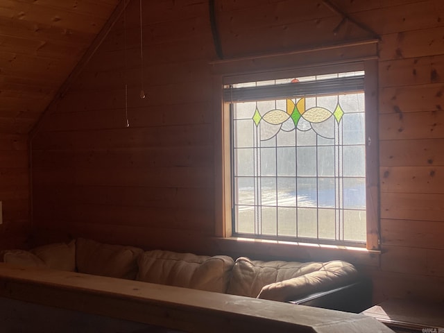 interior space with wood ceiling, multiple windows, wood walls, and lofted ceiling