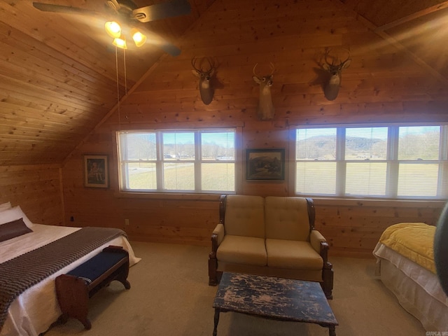 bedroom featuring vaulted ceiling, ceiling fan, wood walls, carpet floors, and wood ceiling