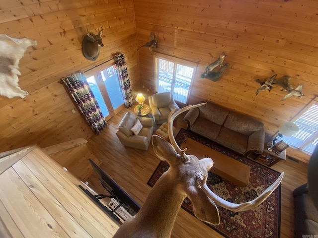 living room with wood walls and hardwood / wood-style flooring