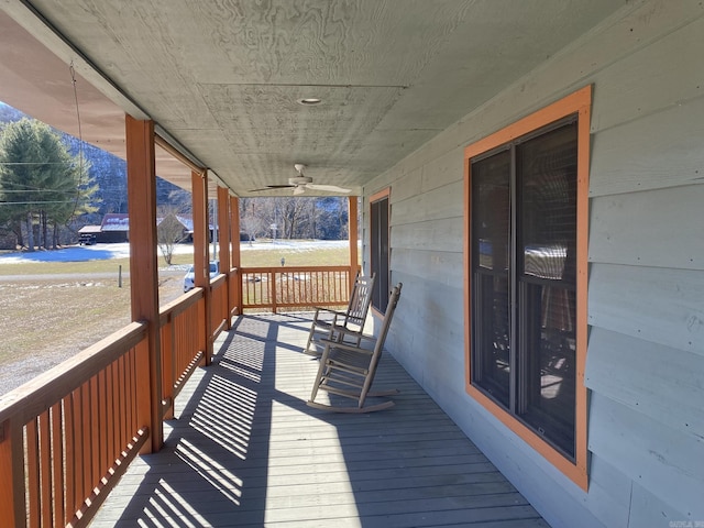 wooden terrace featuring ceiling fan and covered porch