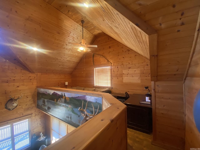 bedroom with wooden walls, vaulted ceiling with beams, and wood ceiling