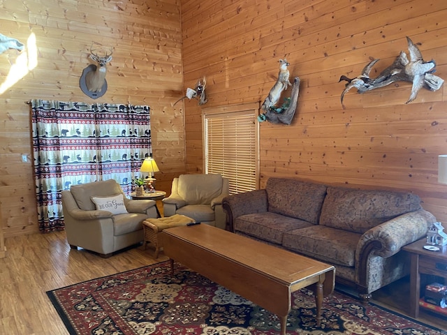 living room with wooden walls and hardwood / wood-style flooring