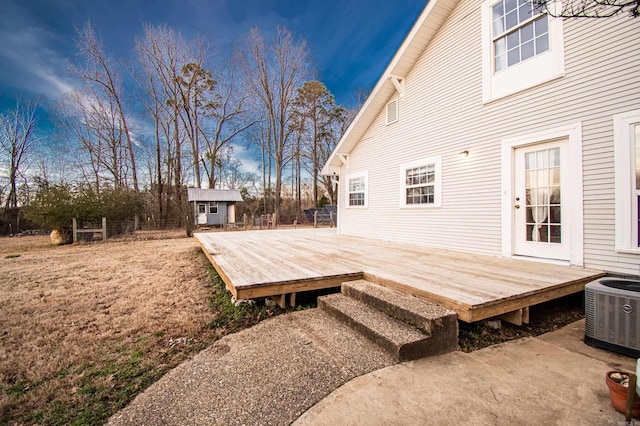 wooden deck featuring cooling unit and an outbuilding