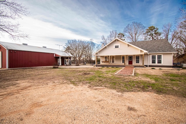 back of house featuring a porch