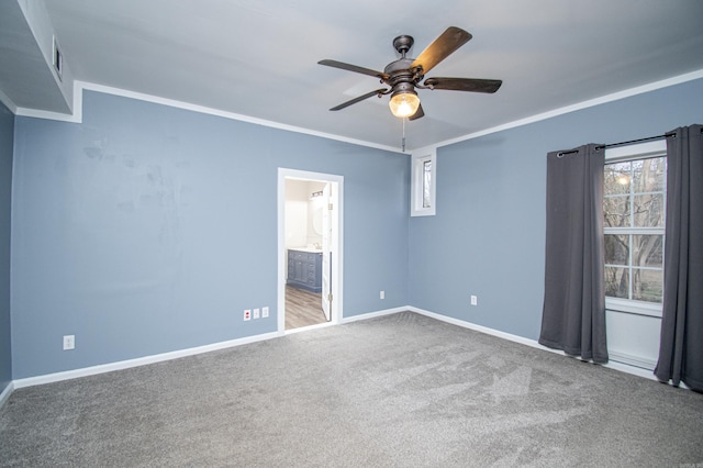 spare room with plenty of natural light, ceiling fan, crown molding, and carpet