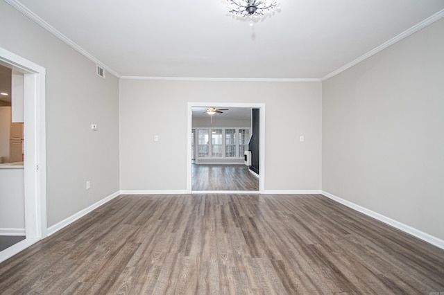 unfurnished room featuring dark wood-type flooring and ornamental molding