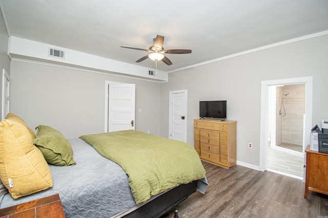 bedroom featuring connected bathroom, ceiling fan, crown molding, and dark hardwood / wood-style floors