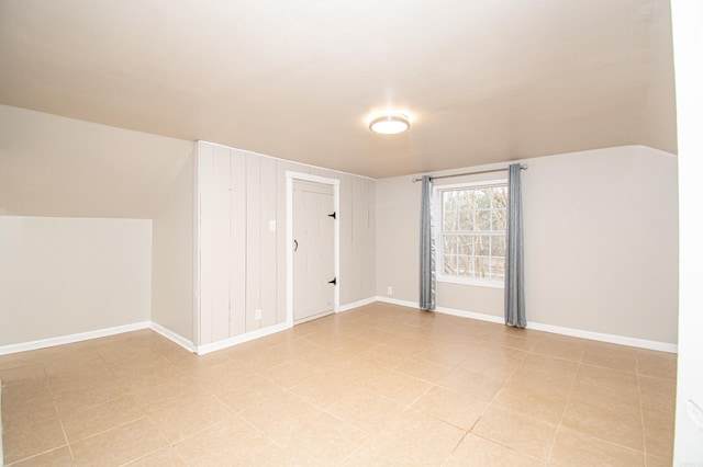 additional living space featuring lofted ceiling