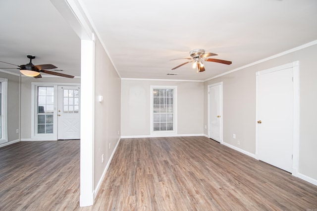 spare room with crown molding and wood-type flooring