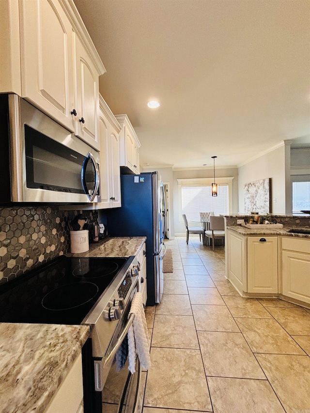 kitchen with light stone counters, decorative light fixtures, stainless steel appliances, white cabinets, and light tile patterned flooring