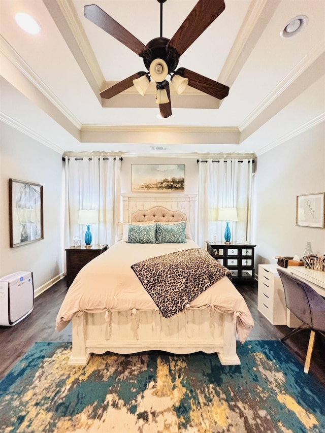 bedroom featuring ceiling fan, ornamental molding, a raised ceiling, and dark hardwood / wood-style floors