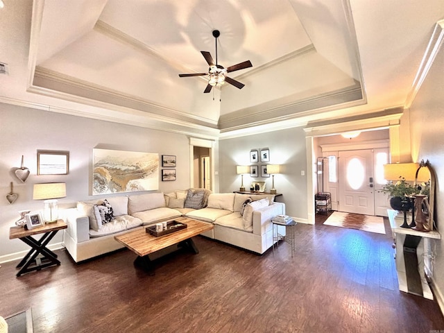 living room featuring a raised ceiling, ceiling fan, crown molding, and dark hardwood / wood-style flooring