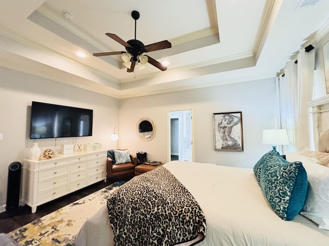 bedroom featuring ceiling fan, a tray ceiling, and crown molding