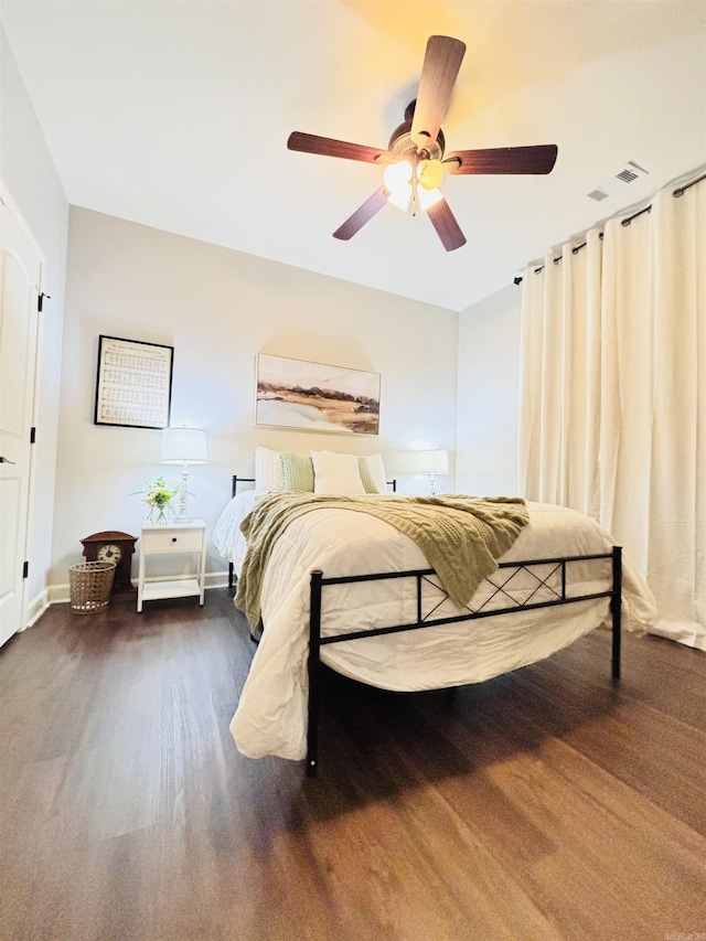 bedroom featuring ceiling fan and dark wood-type flooring