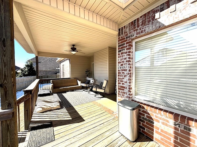 wooden terrace with ceiling fan and outdoor lounge area